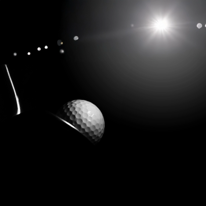 Golf Performance Store | Golf ball on a black background with a spotlight effect