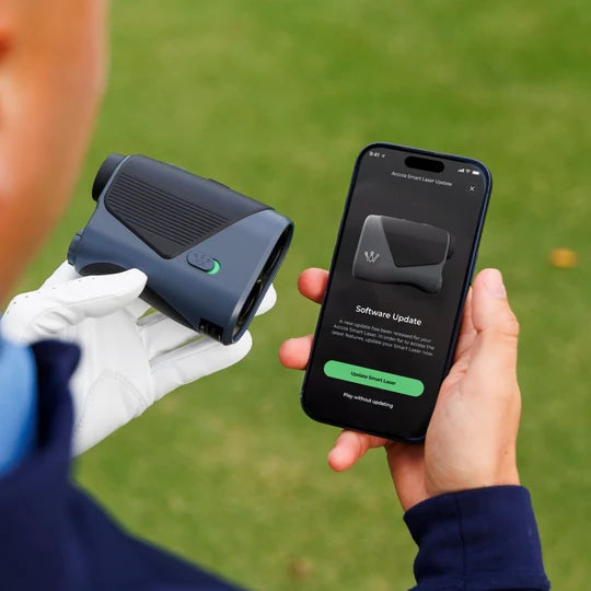 Person holding an Arccos Smart Laserand smartphone with Arccos app showing a software update for the laser
