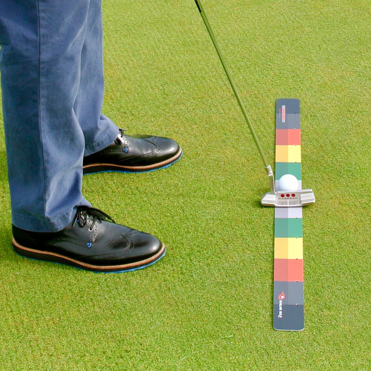 Golf ball on the Stroke Meter with a person's feet and golf club in the background