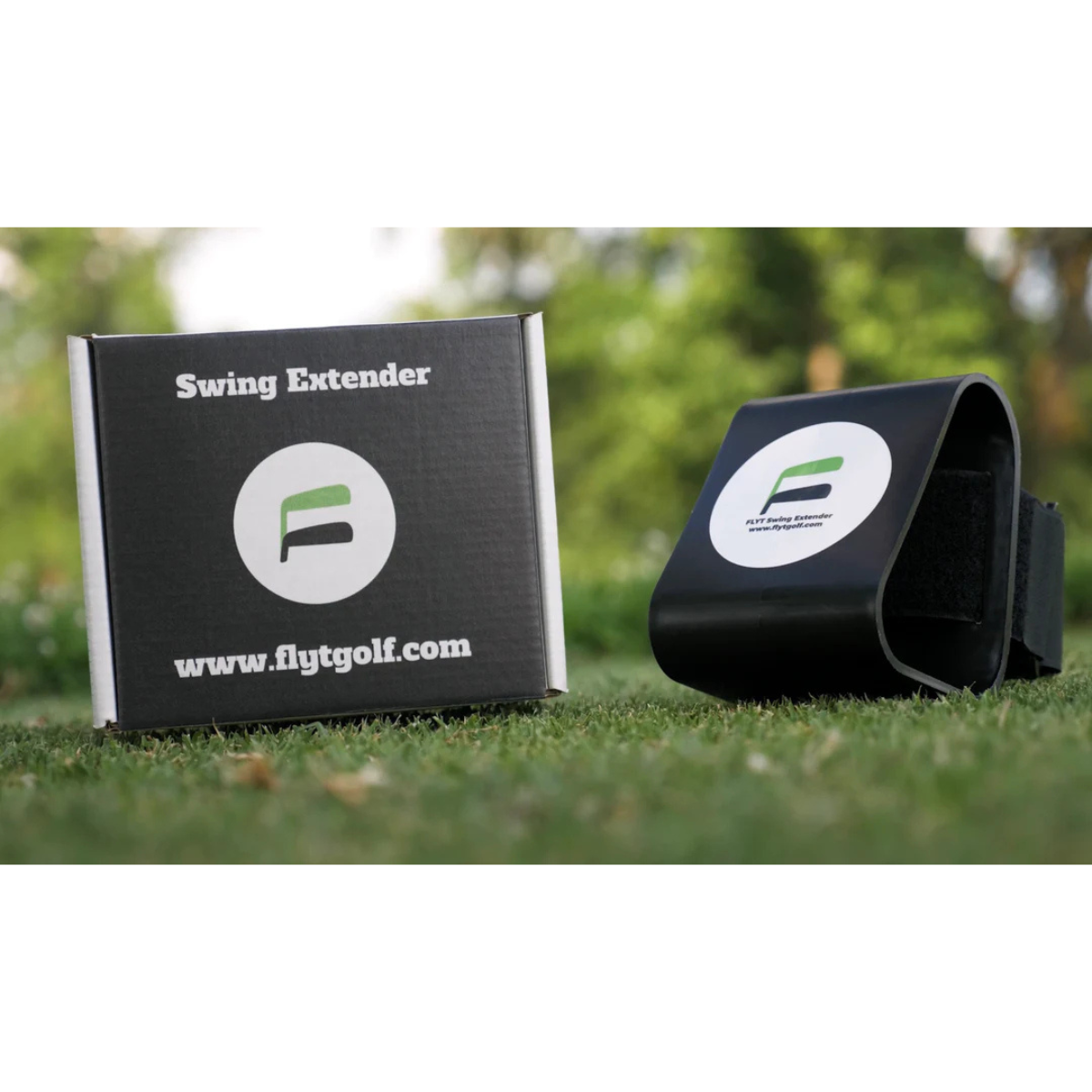 The Flyt Golf Swing Extender with packaging on a grassy background