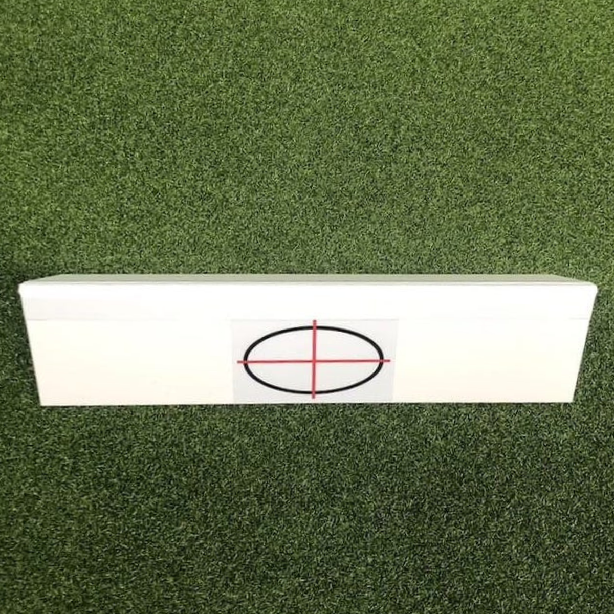 White rectangular target board with a red crosshair on a green textured background