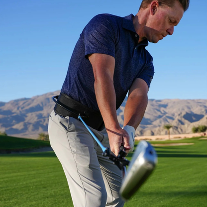 Man playing golf with the PlaneMate on a course with mountains in the background
