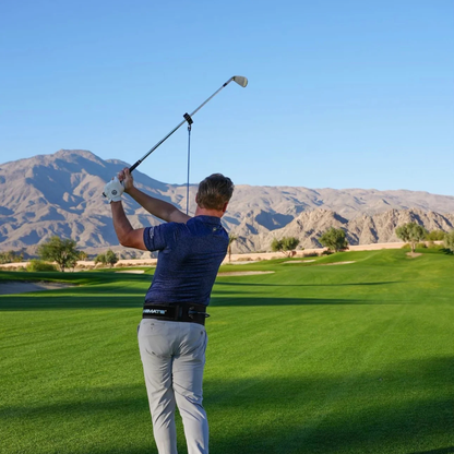 Golfer in action with the PlaneMate on a golf course with mountains in the background