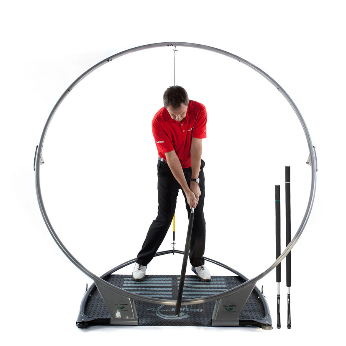 Man practicing golf swing on the PlaneSWING with a white background