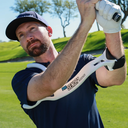 Man holding a golf club and using the ProSENDR Widener on a golf course