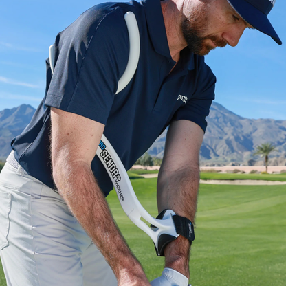 Man on a golf course with the ProSENDR Widener wearing a navy blue shirt and white pants.