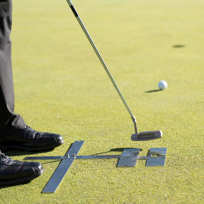 Golf player on a green putting green with a putter and golf ball.