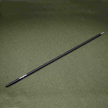 Black cylindrical telescopic rod on a textured green surface