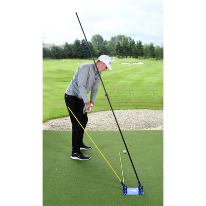 Person on a golf course using a golf training aid to practice their swing.