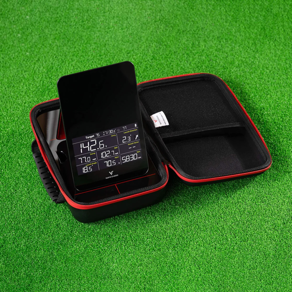 Voice Caddie SC4 Pro Launch monitor in a carrying case on a green background